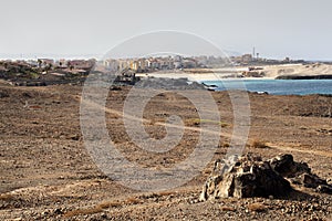 View on the rough rocky coast and the city Sal Rei on Boa Vista