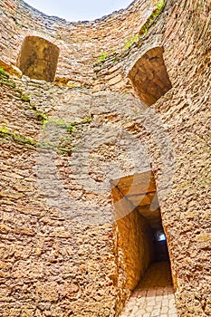 The view on the round wall of the ruined tower of the Akkerman Citadel with deep embrasures, Bilhorod-Dnistrovskyi, Ukraine