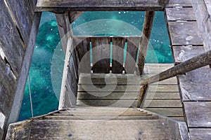 View of rounded wooden stairs look down to the floor.