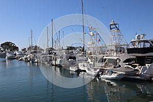 View of a row of boats and yachts in Dana Point Harbor, California.