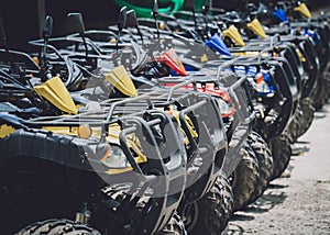 View of row dirty ATVs quad bike