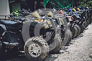 View of row dirty ATVs quad bike