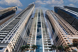 View of a row of very high skyscrapers with details of windows, balconies and doors. taken from a low setting