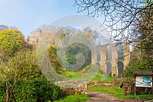 View of ruins of ancient roman palace and acqueduct in a rural area in Italy during a foggy winter day