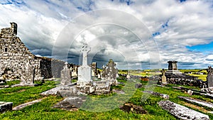 View of the ruins of the medieval church of Killilagh and the graveyard in the village of Doolin