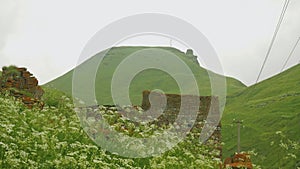 View of ruins of old family fortress and cell tower in mountains