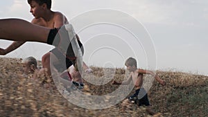 A view of running children, competing on a training in a field