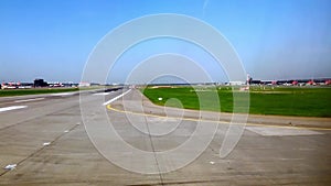 View of the runway from the airplane window. The plane is accelerating for takeoff. Filming through the porthole. Russia