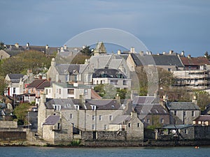 View of a rural city situated in the Shetlands islands of Scotland, nestled near a body of water