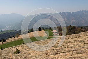 Rural contryside in mountains. Agricultural fields on hills with mountains on background photo