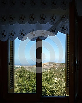 View of rural field from window, Crete, Greece