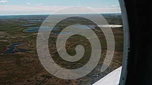 View of Russian tundra its rivers lakes ground from helicopter widow.