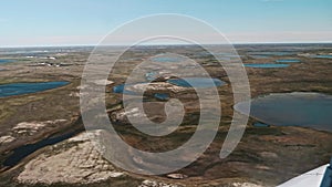 View of Russian tundra its rivers lakes ground from helicopter widow.