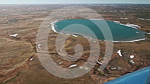 View of Russian tundra its rivers lakes ground from helicopter widow.