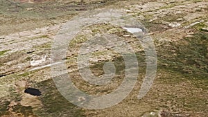 View of Russian tundra its rivers lakes ground from helicopter widow.