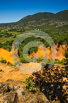 View of Rustrel Village and Bay from the Colourful Ochres of the Provencal Colorado in France
