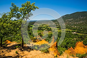 View of Rustrel Village and Bay from the Colourful Ochres of the Provencal Colorado in France