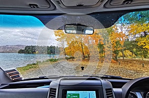 A view from RV windiw on a beautiful lake and autumn coloured trees