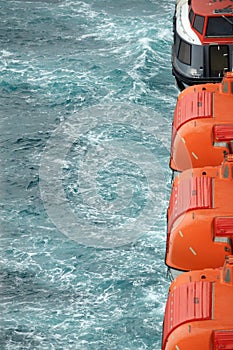 View of safety lifeboats against the background of the sea close up