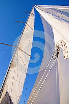 View from a sailboat`s bow with mast and full sails