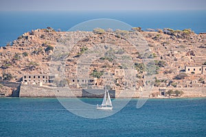 View of sailing boat and Spinalonga Island on Crete, Greece