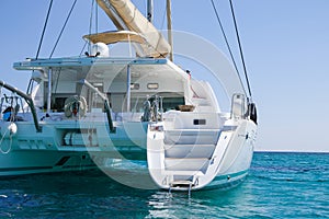 Sailing catamaran in blue waters of the Aegean sea.