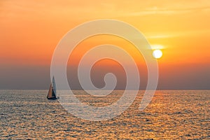 View of a sailing yacht on the background of a golden sunset from Venice fishing pier.California.USA