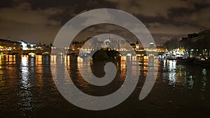 View of the Saine river, Cite island and Pont Neuf from Pont des Arts before sunrise