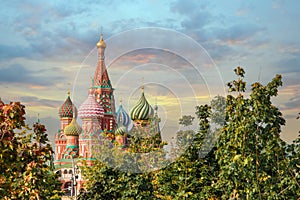 View of Saint Basil`s Cathedral in the morning, Red Square, Moscow, Russia. through the green trees