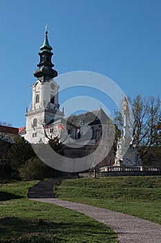 View of Saint Emmeram Basilica main tower surrounded by Nitra castle, with plague column with Immaculate statue on top.