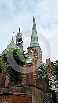 View of Saint James church and monument of german poet and playwright Emanuel von Geibel, Lubeck, Germany