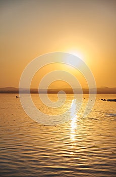 View of the salt lake with a beautiful pink water. Sunset orange sun, the neighborhood.Las salinas, Torrevieja, Spain