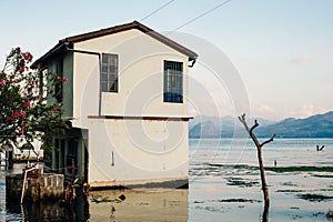 view of San Juan La Laguna on Lake Atitlan. house in the water photo