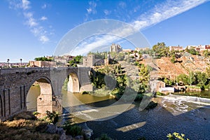 View of the San Martin Bridge crossing the Tagus to enter the old city of Toledo on the hill where you see the Old Cathedral