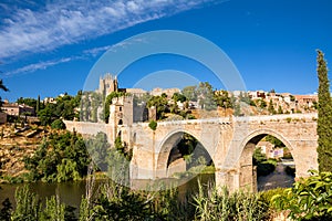 View of the San Martin Bridge crossing the Tagus to enter the old city of Toledo on the hill where you see the Old Cathedral