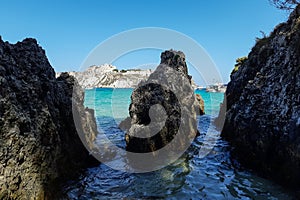 View of San Nicola Island trought the rock of cala delle arene beach in San Domino island