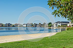 View of Sanctuary Lakes with some luxury waterfront houses in the distance.