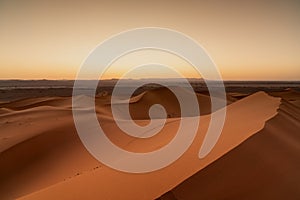 view of the sand dunes at Erg Chebbi in Morocco at sunset
