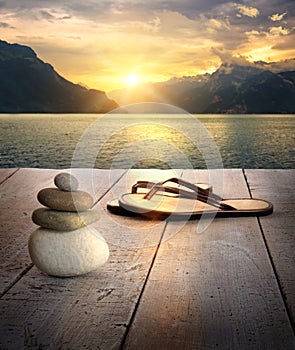 View of sandals and rocks on dock