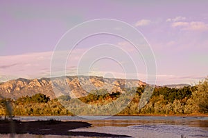 View of the Sandia Mountains and the Bosque along the Rio Grande River at sunset in Albuquerque, New Mexico