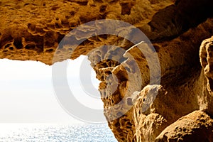 View from the sandstone cave to the sea. Close up sandstone texture background, natural surface