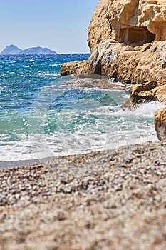 View of sandy beach, sealine, waves, cliff and blue sky in the summer sunny day