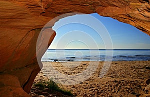 View on a sandy seashore from a cave