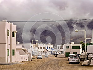 View into a sandy street in the surfing town of La Caleta de Famara on Lanzarote