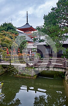 View of Sanju-no-to pagoda over the watercourse with stone bridges at Kiyomizu-dera. Kyoto. Japan