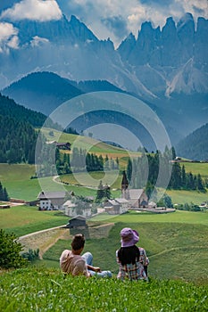 view of Santa Maddalena church in Dolomites, Italian Alps. Val Di Funes valley . Lonely church on green meadow on