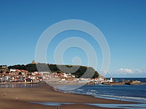 scarborough south bay with beach and town on a sunlit summer day with the harbour and castle in the distance