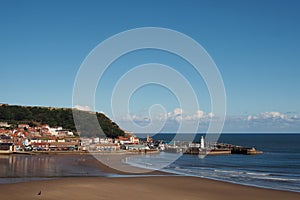 view of scarborough south bay with beach and town on a sunlit summer day with the harbour and castle