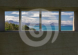 View on scenic landscape of atlantic coastline through the window bars, basque country, france