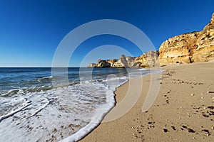View of the scenic Marinha Beach Praia da Marinha, with seagulls in the sand, in the Algarve region